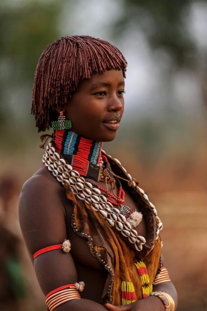 a woman with a necklace and headdress on